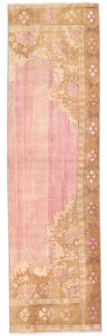 Decorative rug with floral patterns in pink and beige on a plain background