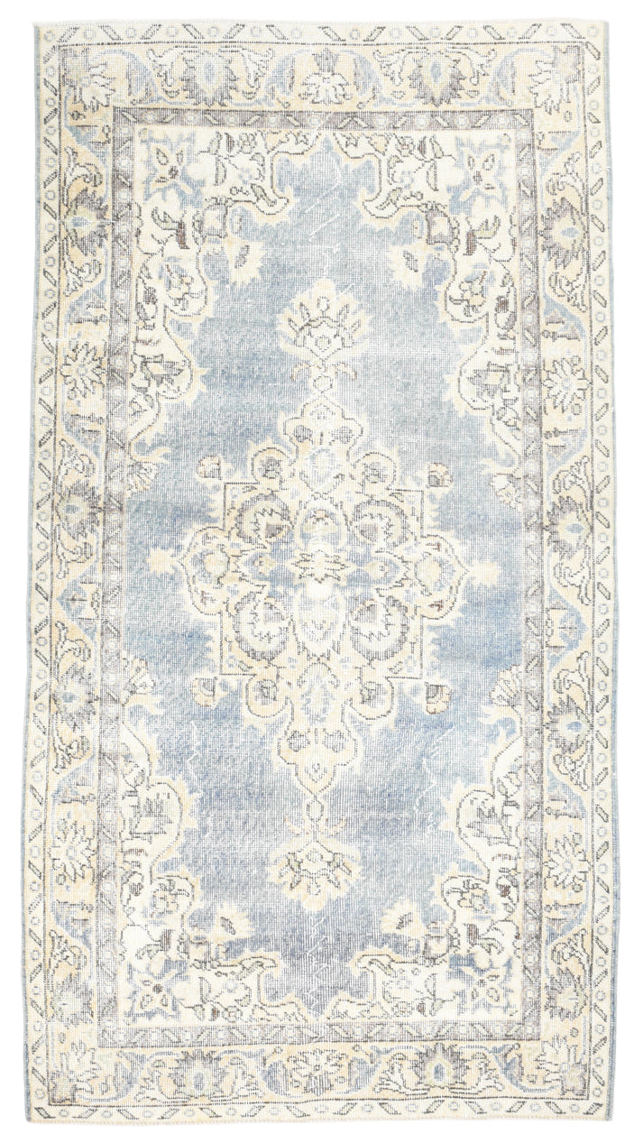 Decorative rug with intricate patterns on a light blue background