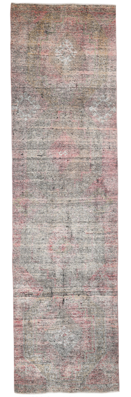 Long, narrow rug with a patterned design on a plain background