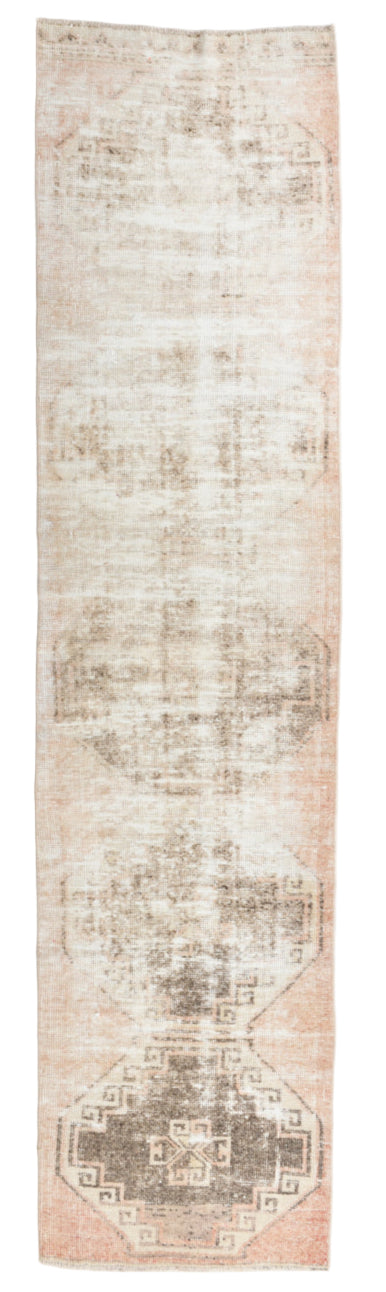 Long, narrow rug with a textured pattern on a plain background