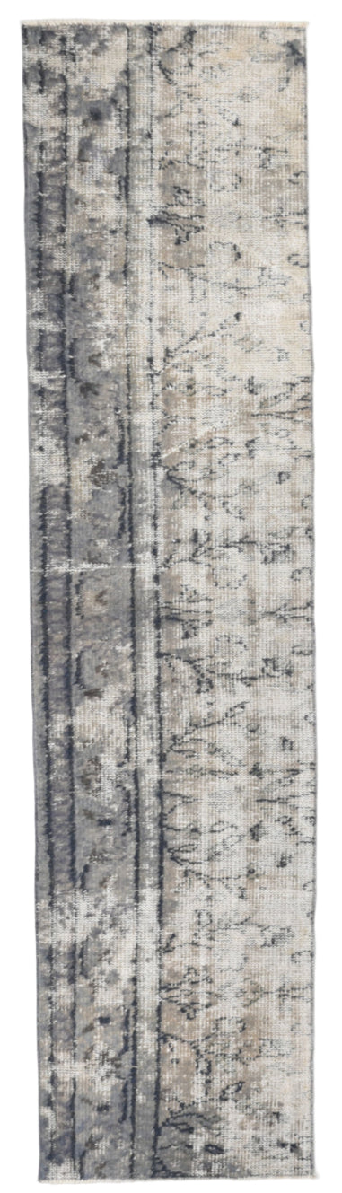 Long rectangular rug with a patterned design on a plain background