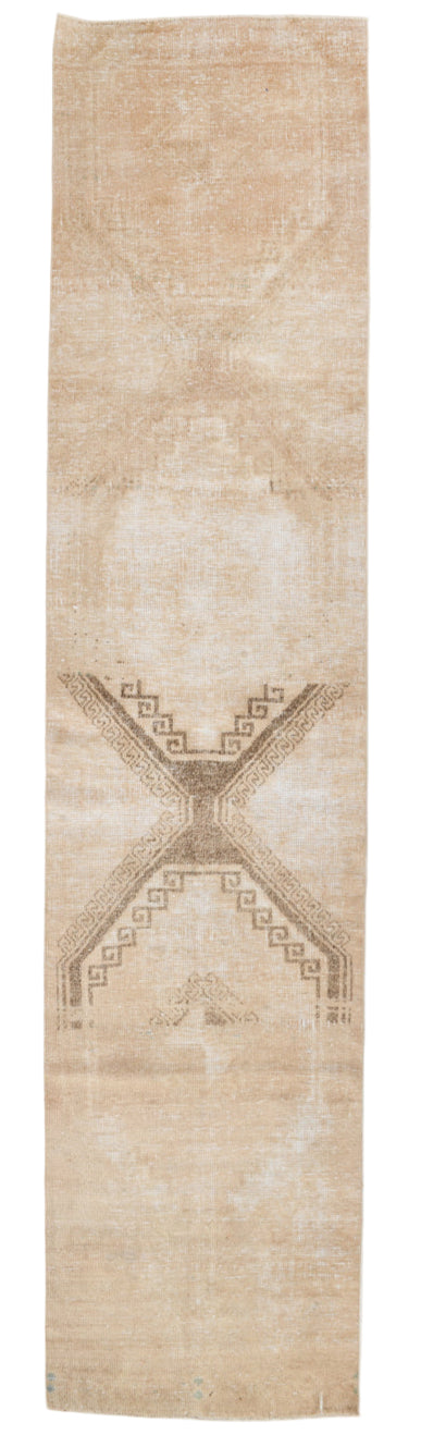Beige rug with geometric pattern on a plain background