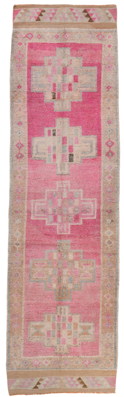 Pink and beige patterned rug with geometric design