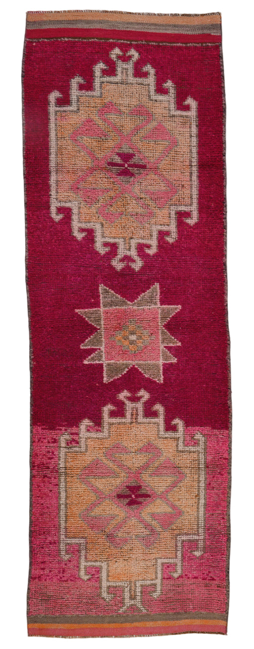 Woven textile with geometric patterns on a red background
