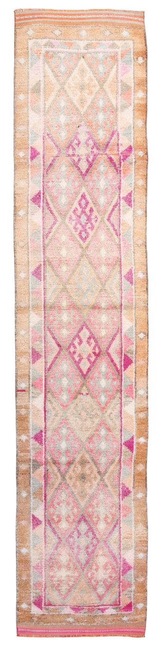 Decorative pink and beige patterned rug on a white background