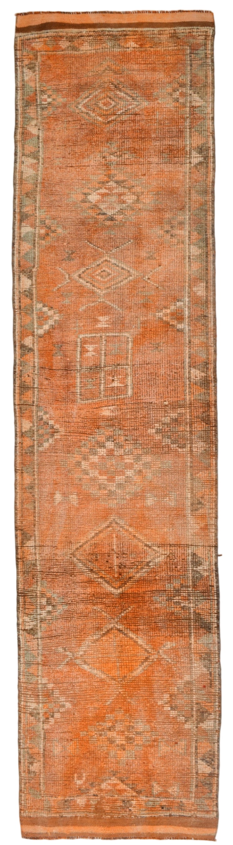 Long, narrow rug with geometric patterns on a plain background