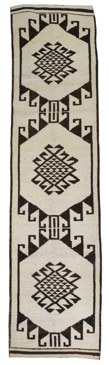 Textile with geometric pattern on a white background dark brown and beige rug