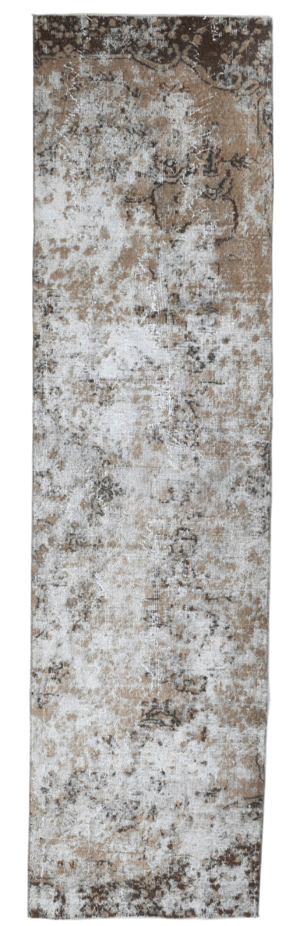 Textured brown and beige patterned rug on a white background