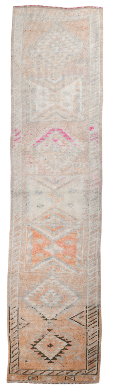 Long narrow rug with geometric pattern on a white background