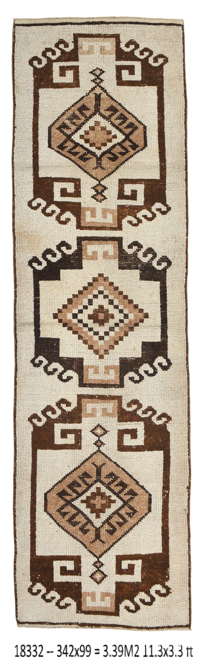 Geometric patterned rug with brown and beige colors on a white background
