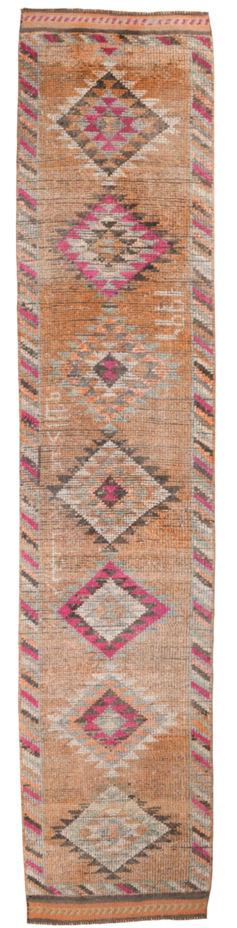 Tall narrow rug with geometric pattern on a white background