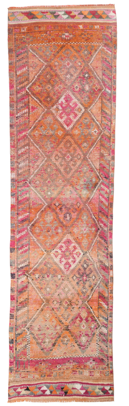 Colorful patterned rug with geometric design on a plain background