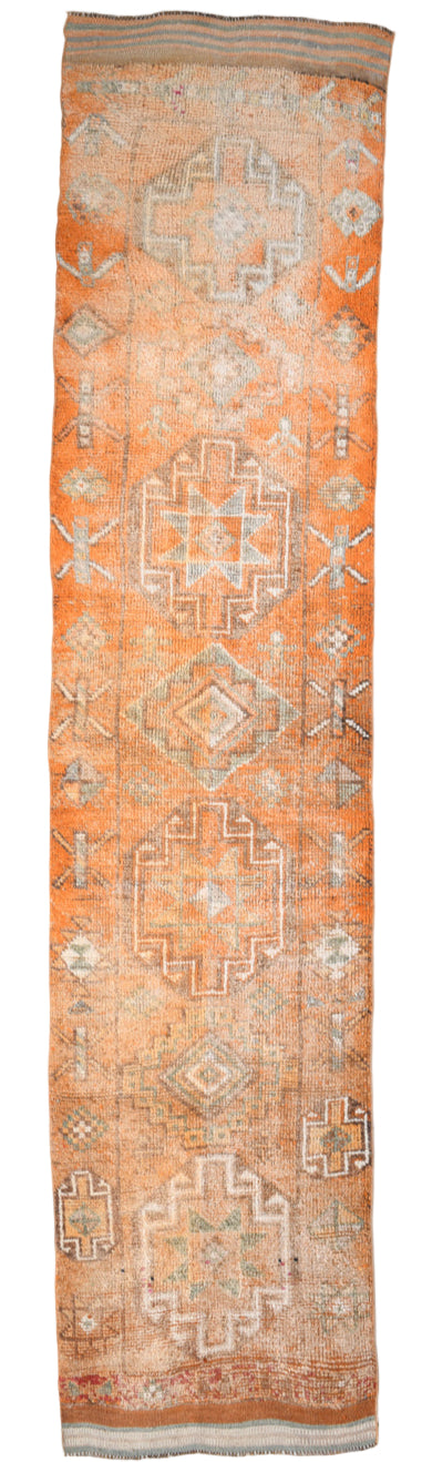 Long rectangular rug with geometric pattern on a white background