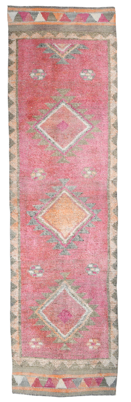 Pink runner rug with geometric patterns