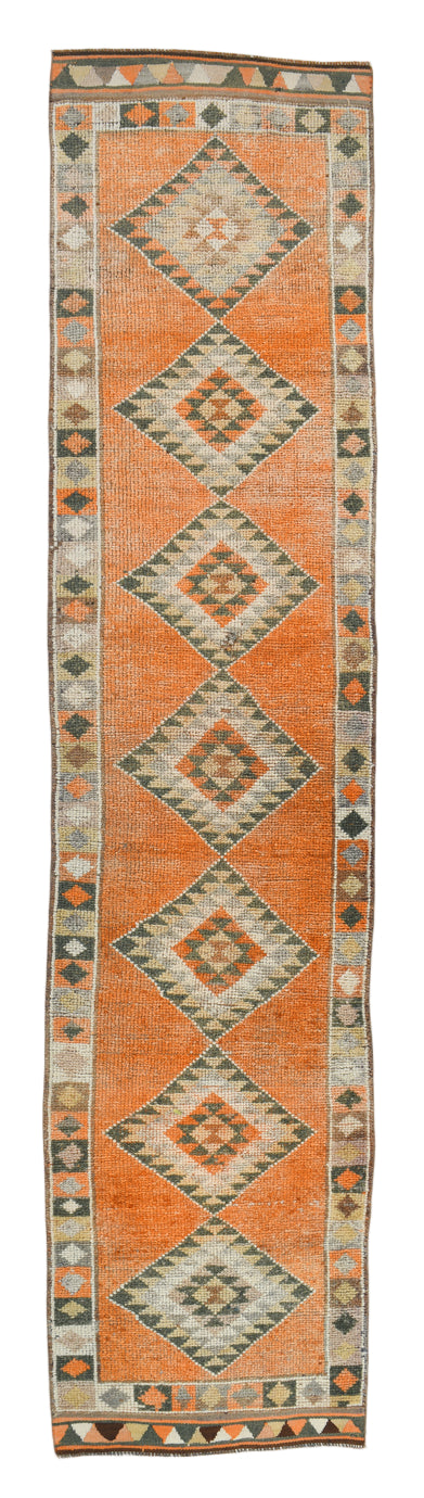 Long narrow rug with geometric pattern on a plain background