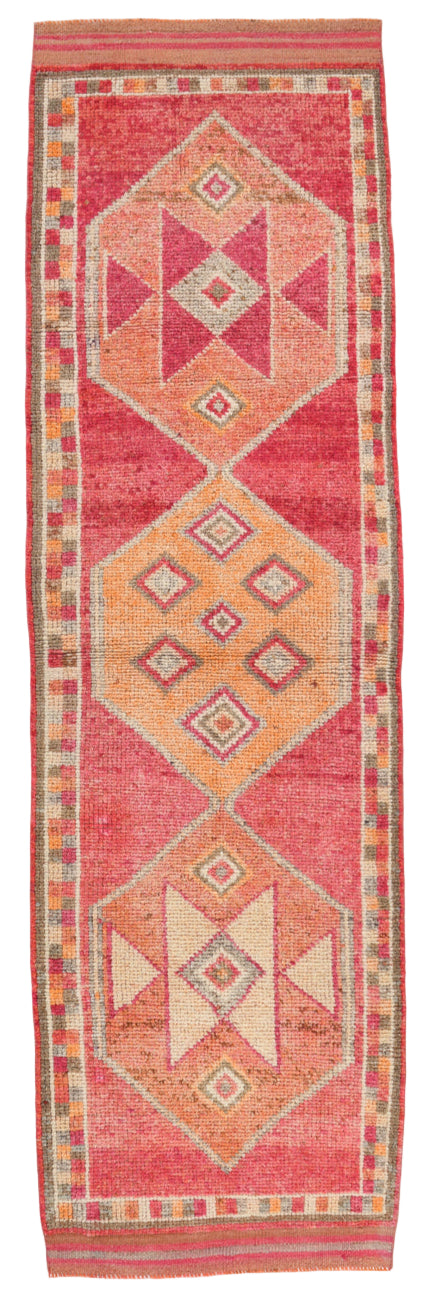 Red runner rug with geometric pattern on a white background