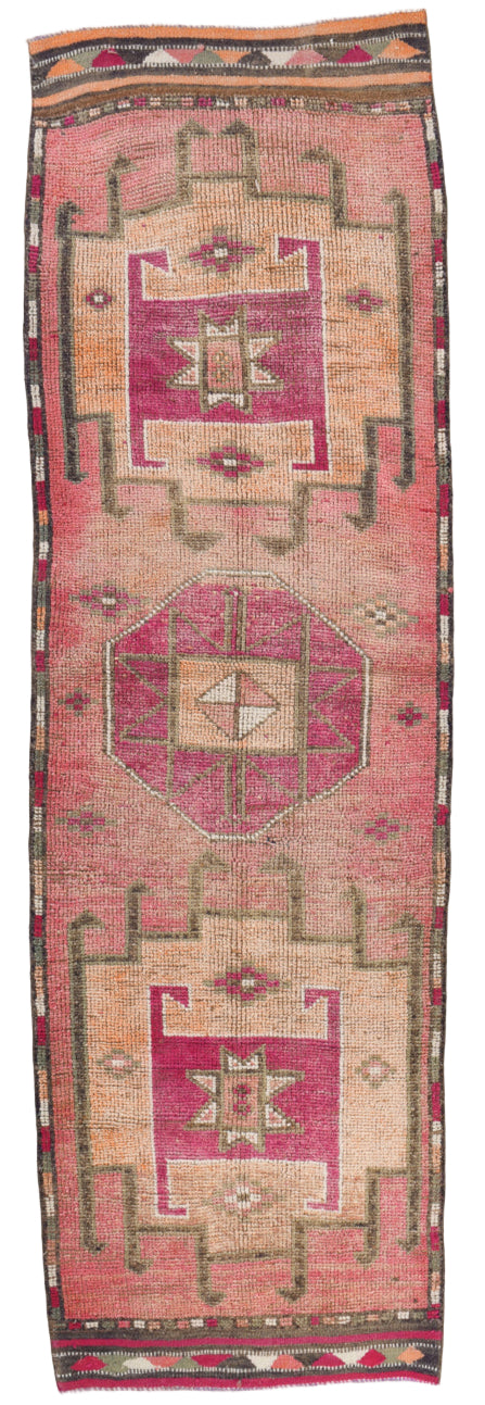 Traditional patterned rug with geometric design on a plain background