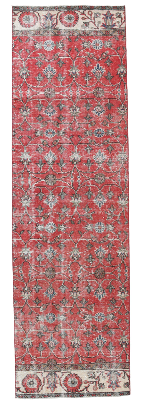 Decorative red rug with intricate patterns on a white background