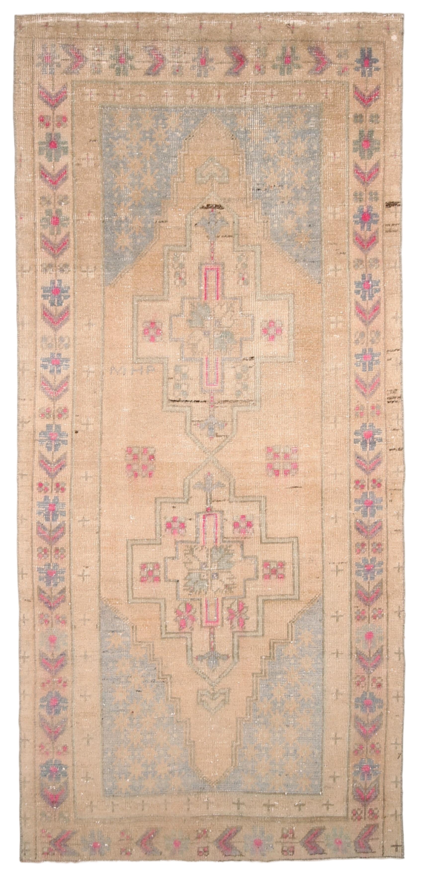 Vintage rug with intricate patterns and colors on a plain background