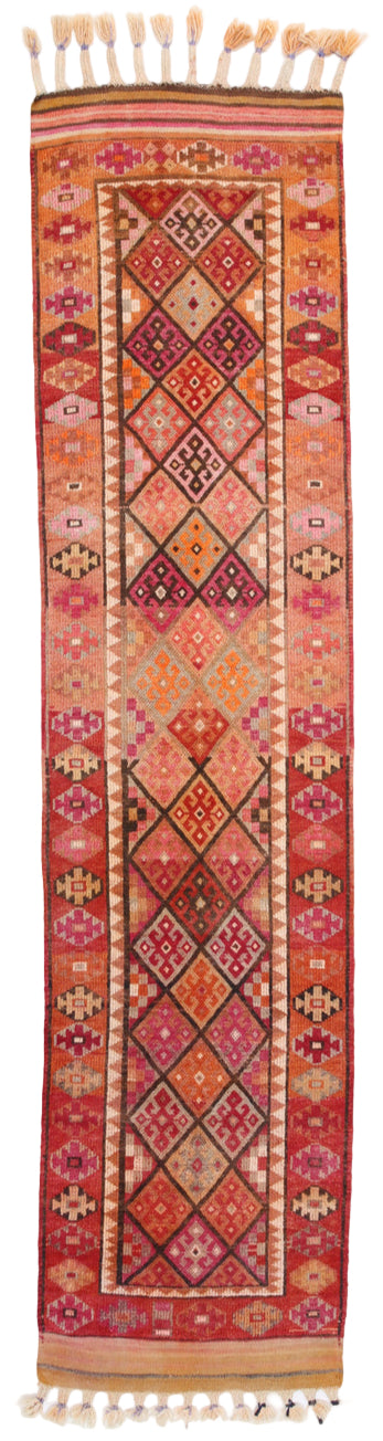 Decorative rug with intricate patterns and tassels on a plain background
