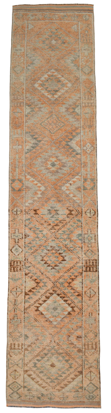 Long rectangular rug with geometric pattern on a plain background