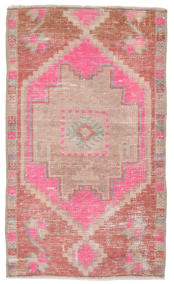 Decorative pink and beige patterned rug on a white background