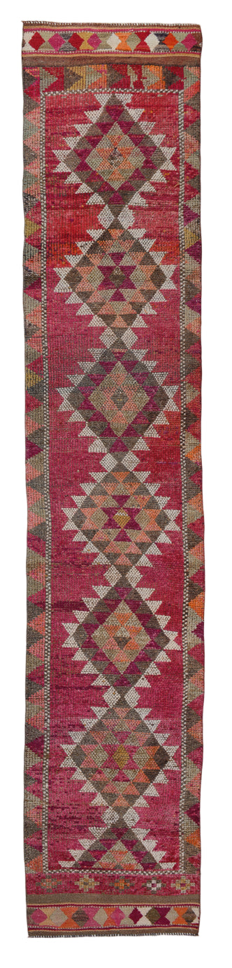 Traditional kilim runner with geometric pattern on a white background