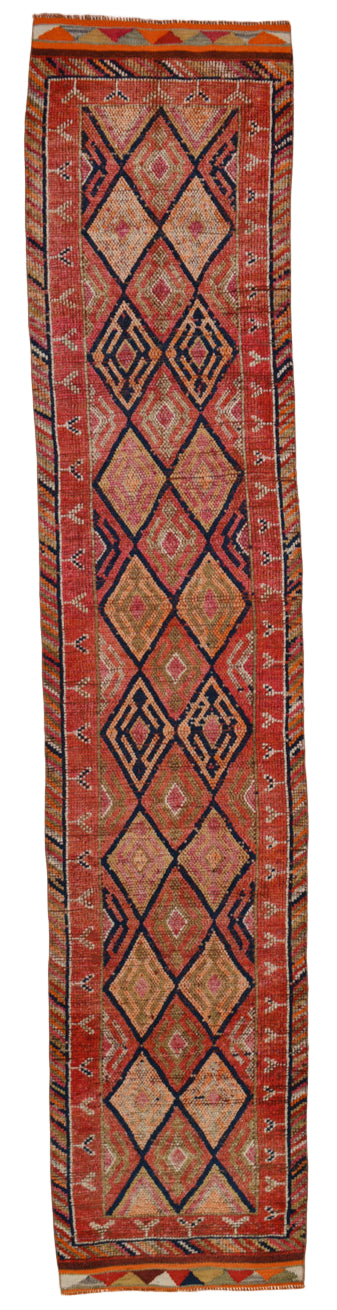 Long, narrow patterned rug with geometric design on a plain background