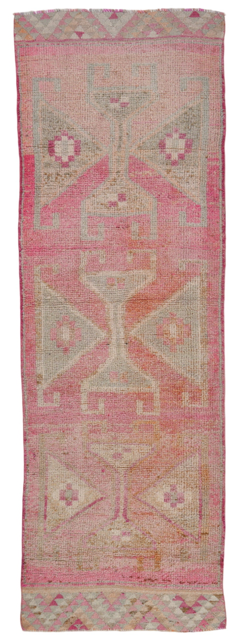 Textile with pink and beige geometric pattern on a white background