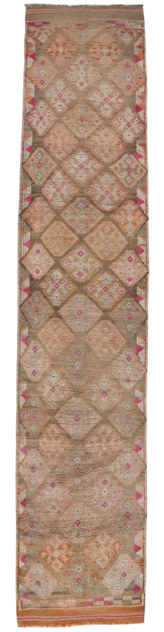Long vertical rug with geometric pattern on a plain background