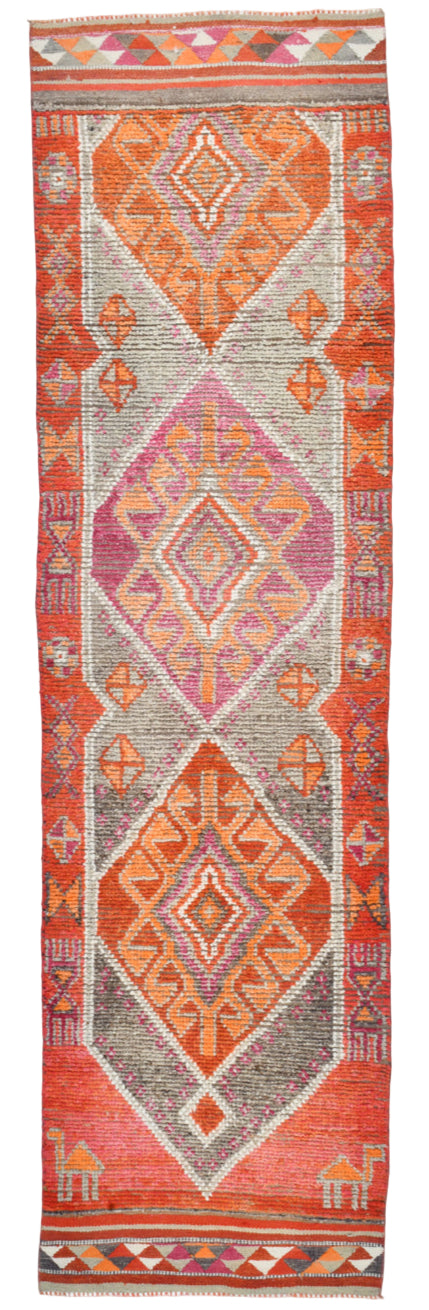 Decorative rug with geometric pattern on a red background