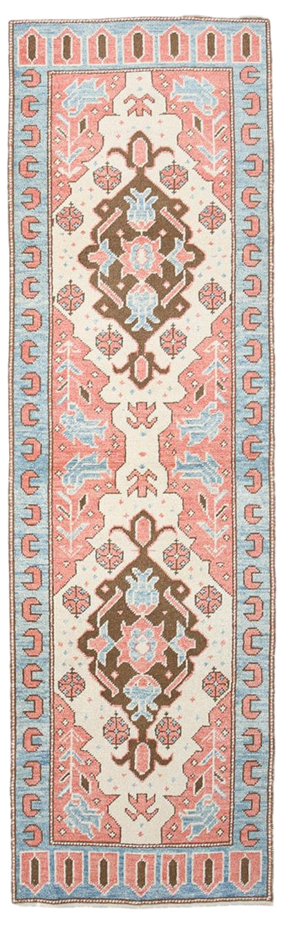Decorative rug with intricate patterns in red, blue, and beige on a white background