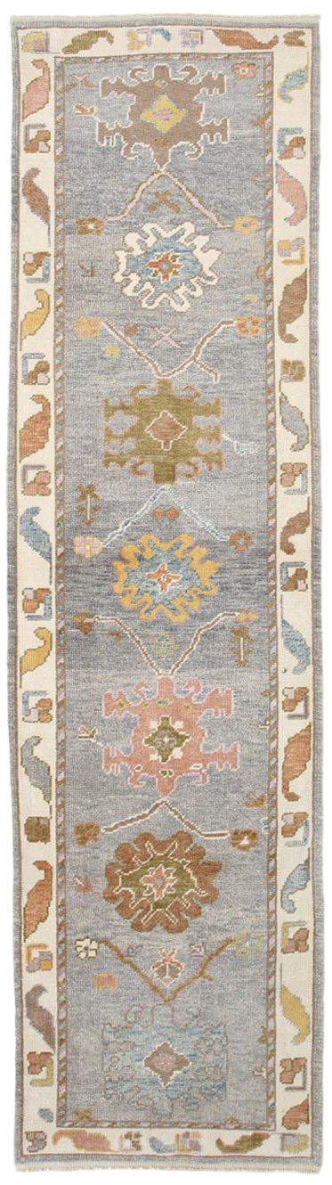 Decorative runner rug with geometric patterns on a light blue background