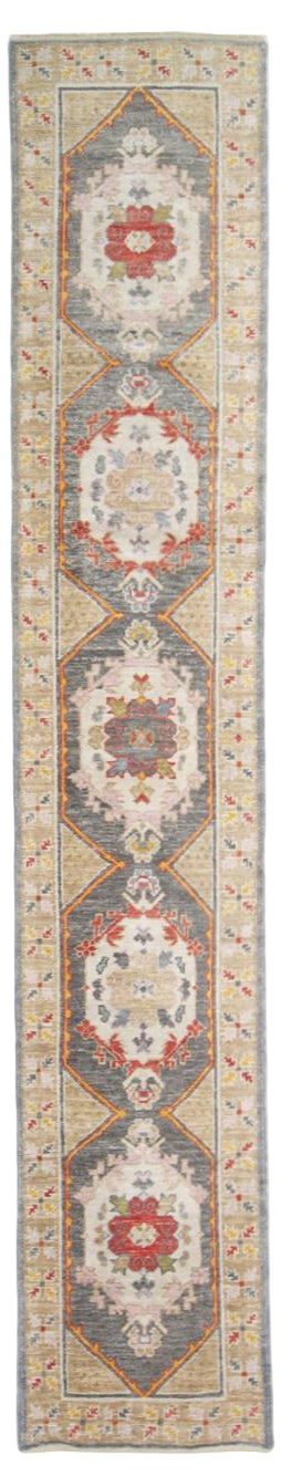 Long rectangular rug with decorative pattern on a plain background