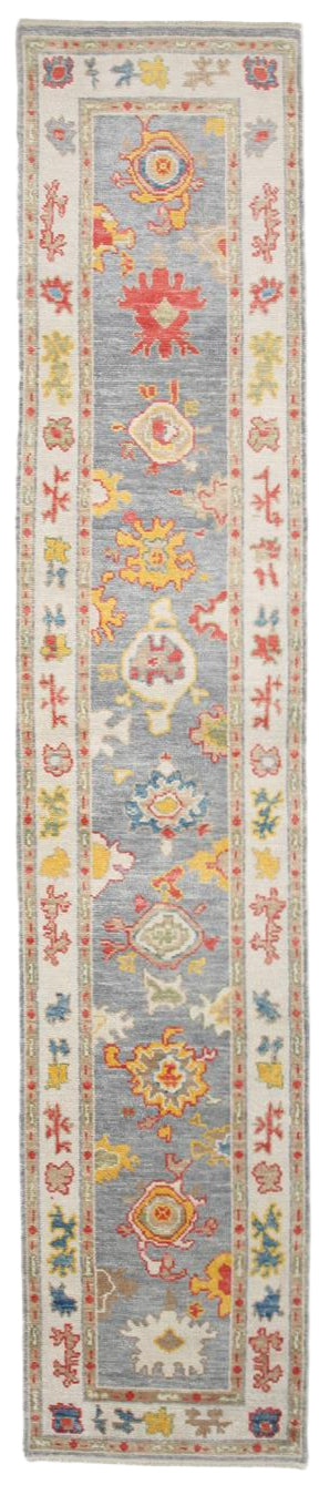 Long, narrow decorative rug with colorful floral patterns on a light blue background