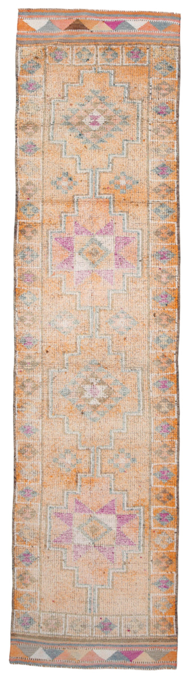 Long rectangular rug with intricate geometric pattern on a plain background