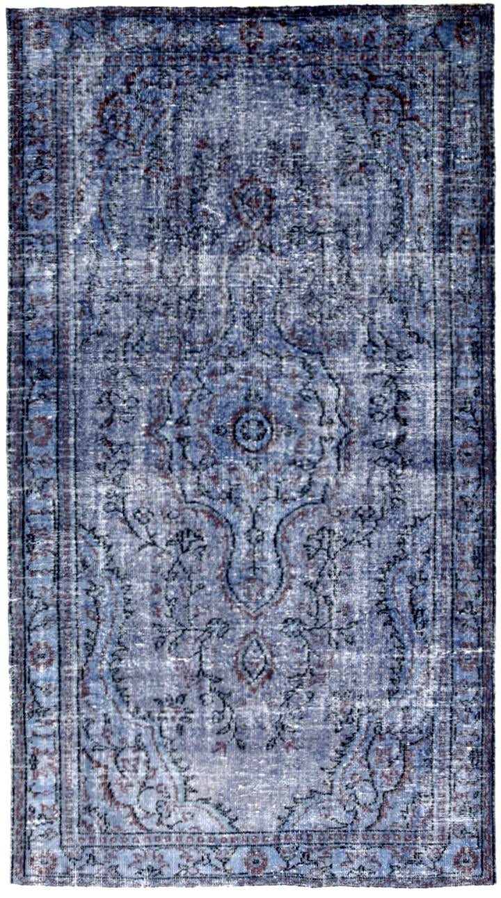 Blue patterned rug with intricate designs on a white background