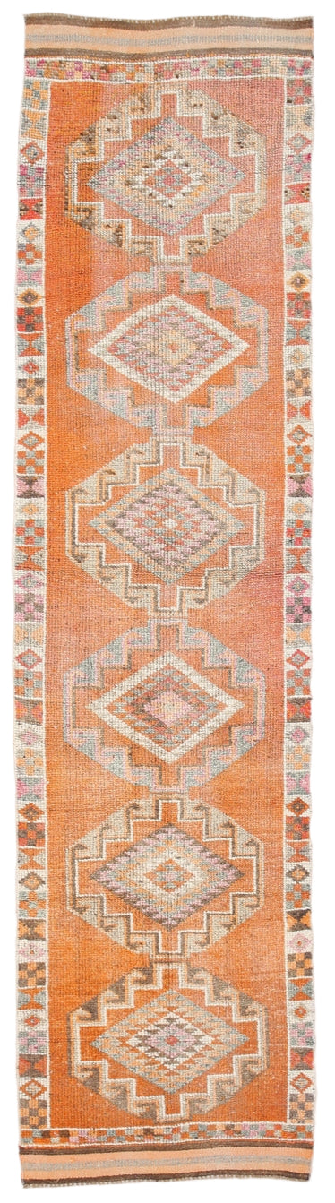 Traditional patterned rug with geometric design on a plain background