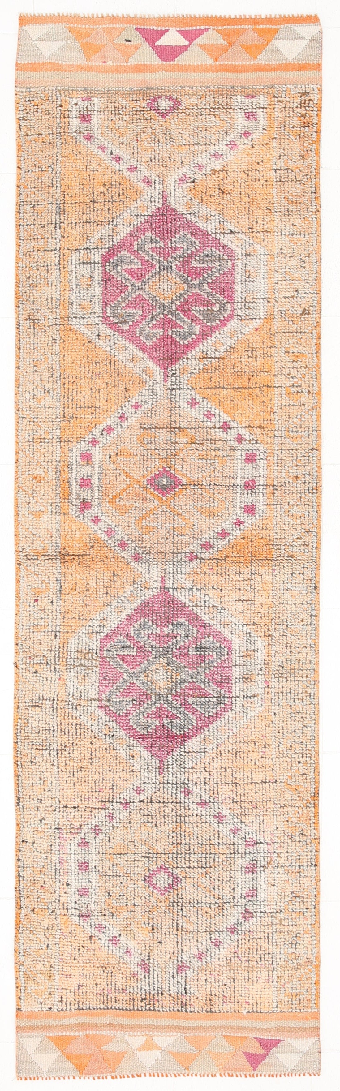 Patterned rug with geometric design on a plain background