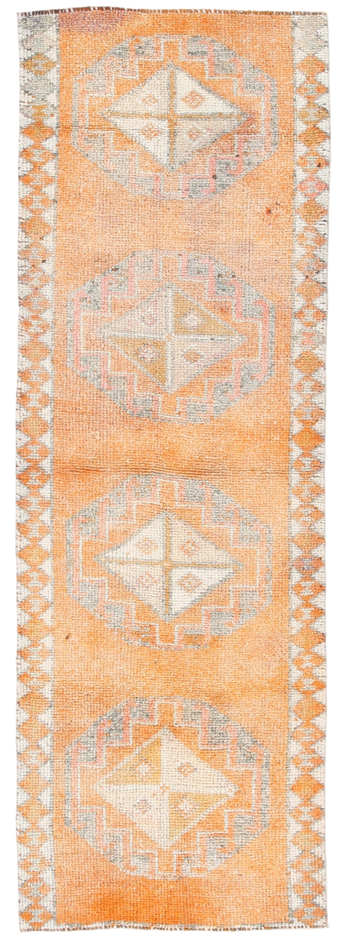 Woven rug with geometric patterns on a light background