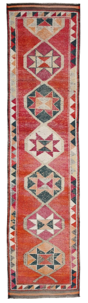 Decorative rug with geometric pattern on a red background