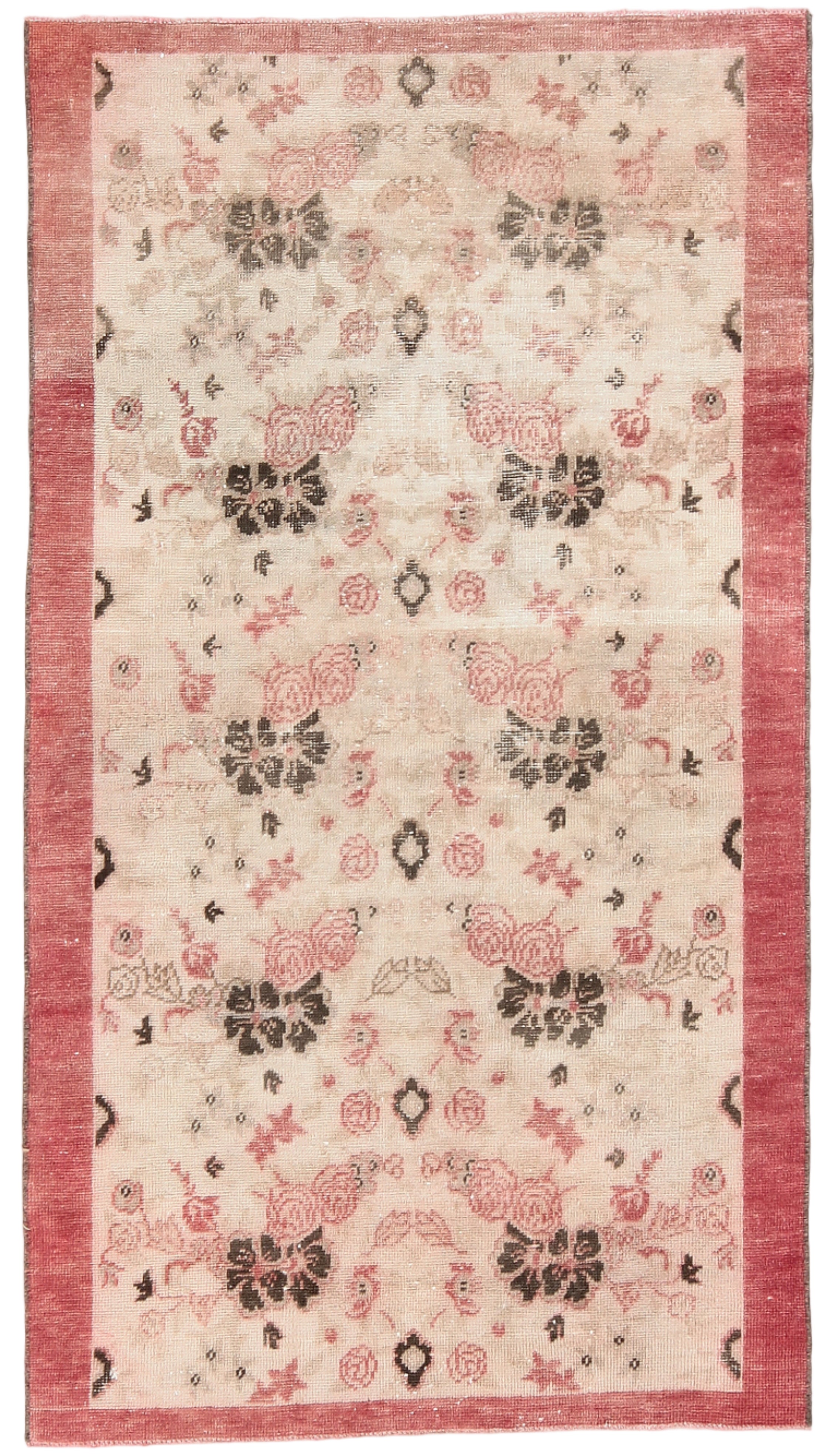 Floral patterned rug with a red border on a plain background