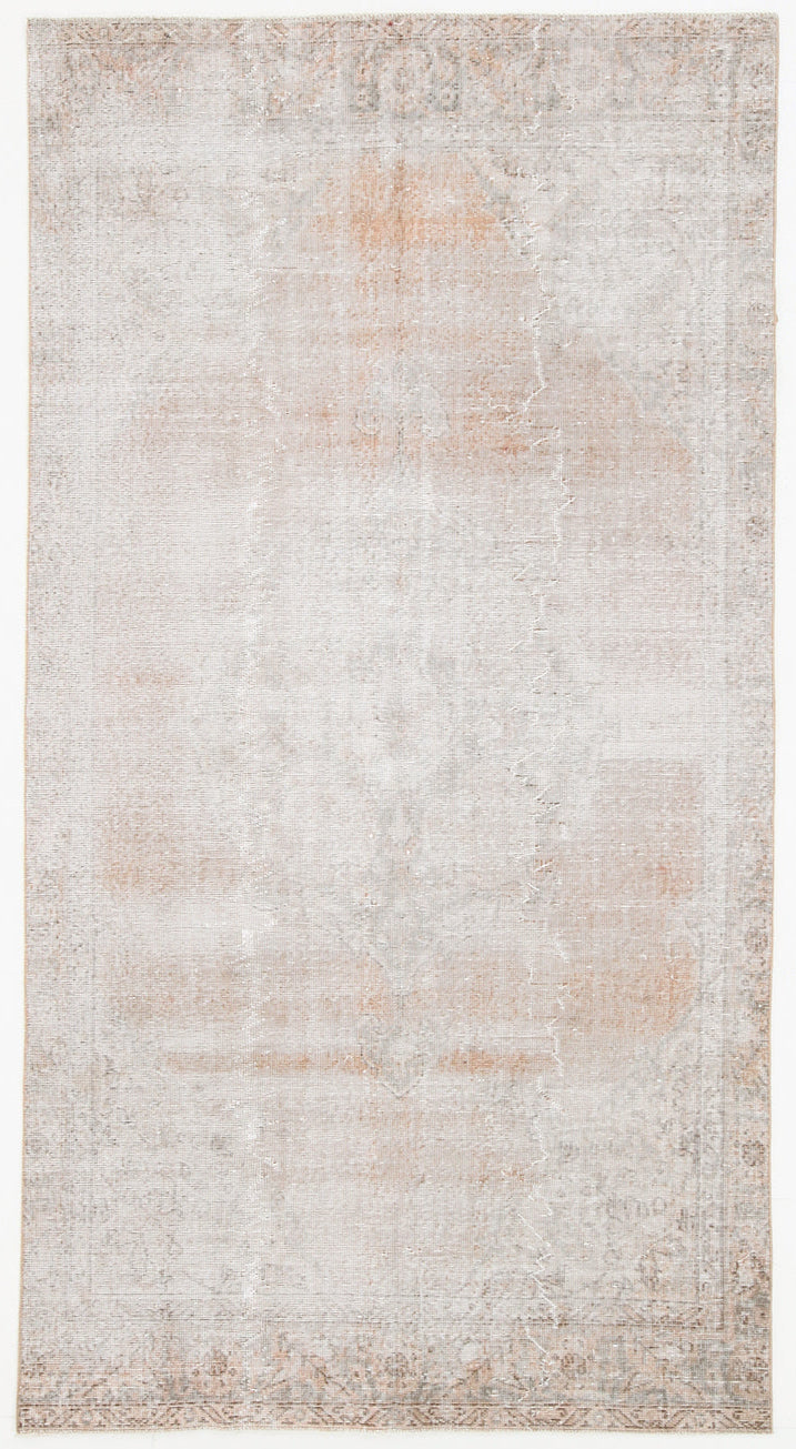 Textured area rug with a neutral color palette on a white background
