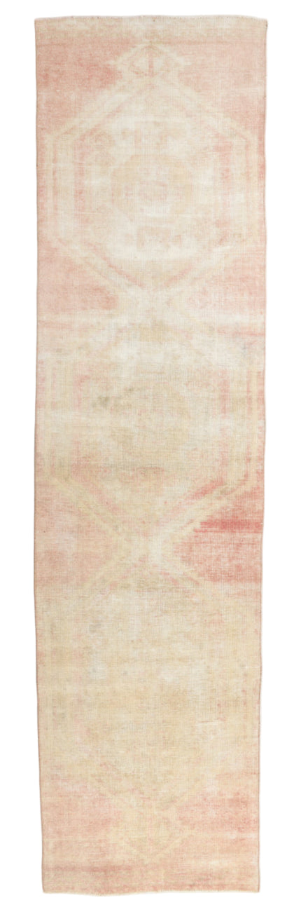Long narrow rug with a subtle pattern on a plain background
