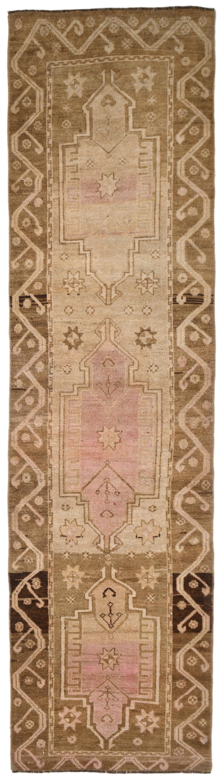Long narrow brown runner rug with intricate patterns and colors 