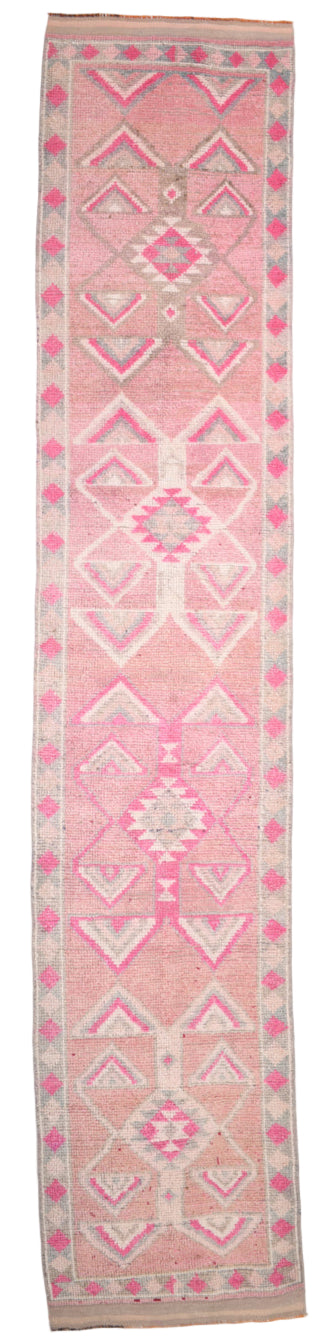 Pink and white patterned rug with geometric designs