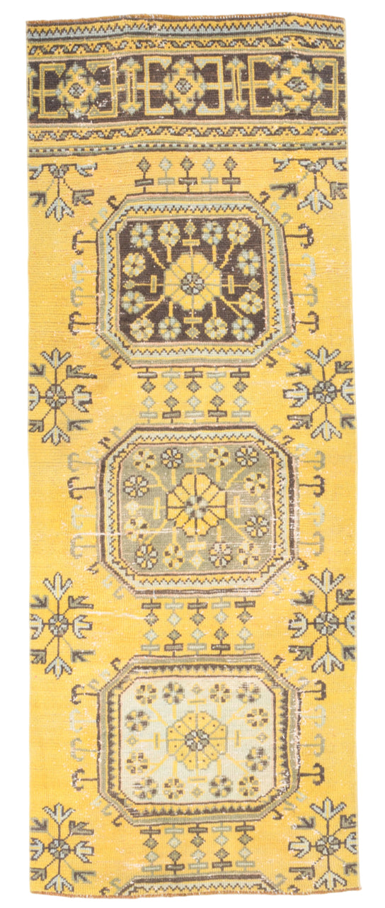 Decorative rug with geometric pattern on a yellow background