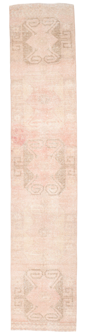 Beige runner rug with geometric pattern on a plain background