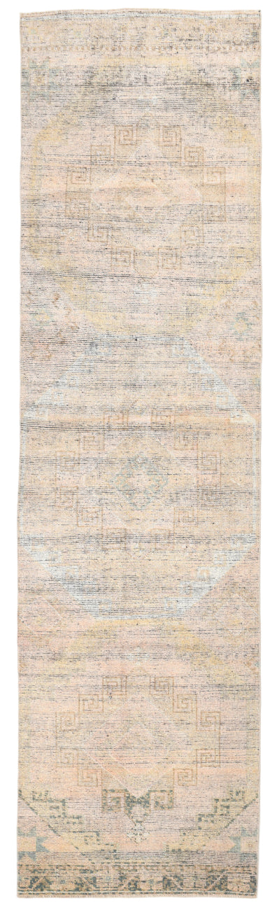Long, narrow rug with a neutral color palette on a white background