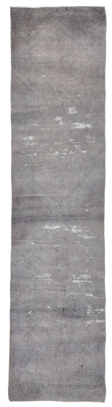 Gray textured rug with a subtle pattern on a white background